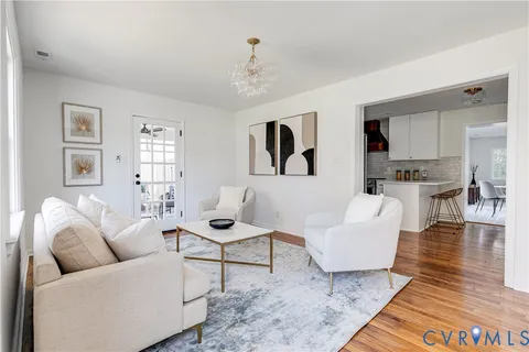 a living room with furniture a rug and a window