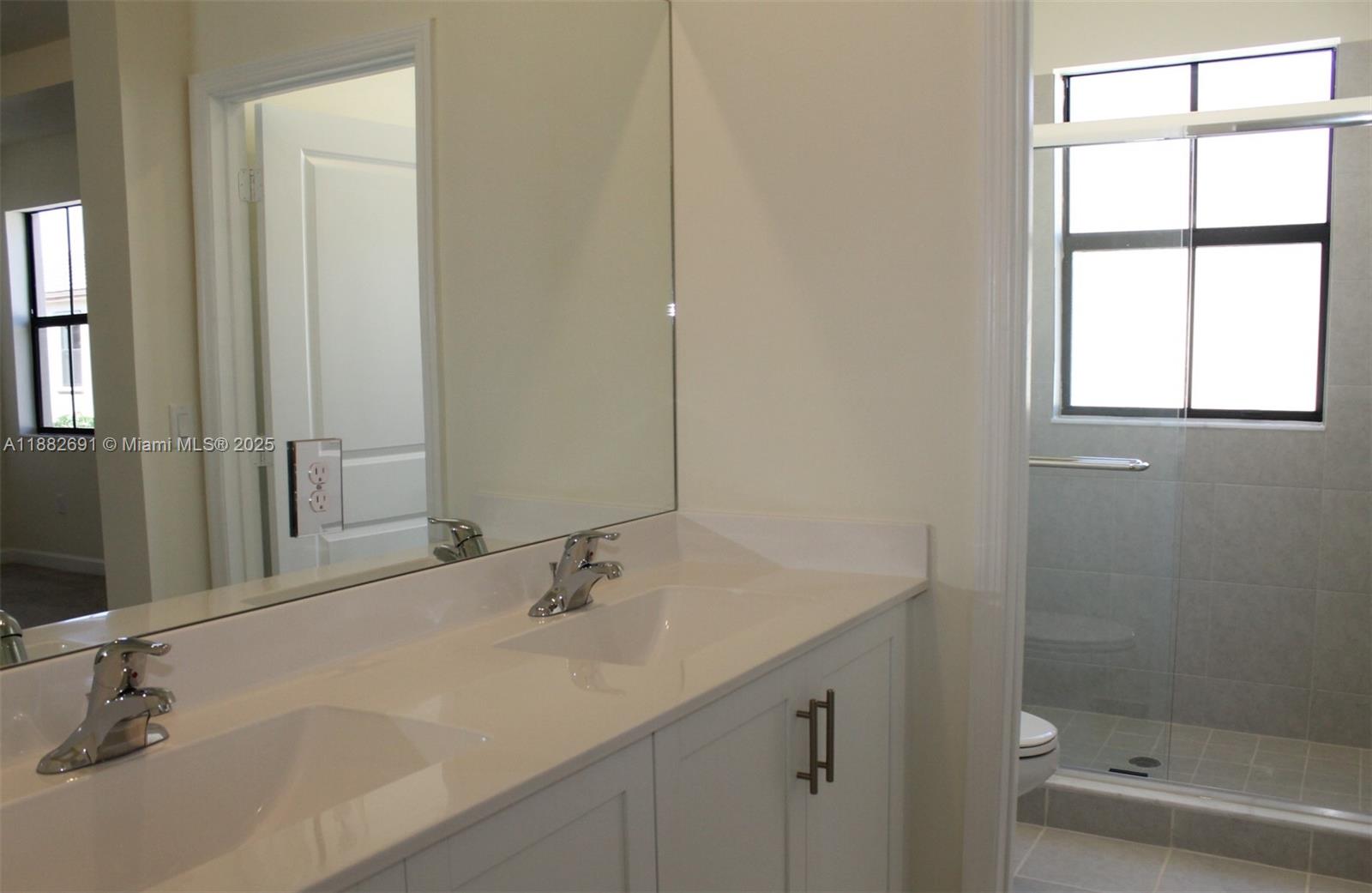 11100 West 33rd Way, Unit 11100 Hialeah, FL 33018 - Photo 19 of 26 a bathroom with a sink and a mirror