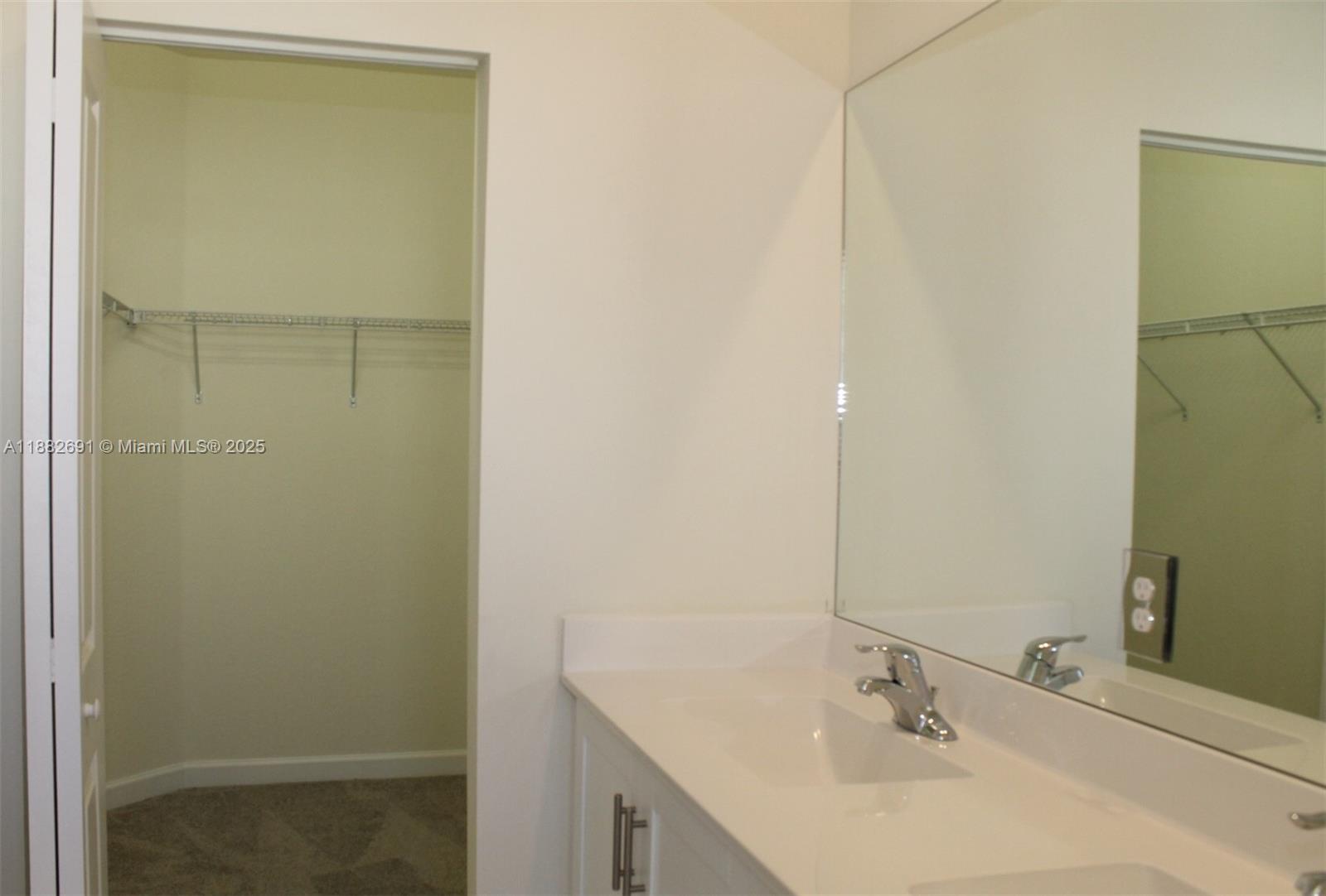 11100 West 33rd Way, Unit 11100 Hialeah, FL 33018 - Photo 20 of 26 a bathroom with a sink and mirror