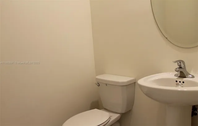 a white toilet sitting next to a white sink