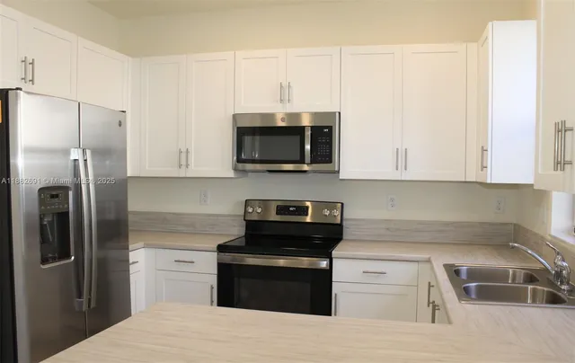 a kitchen with a refrigerator stove and microwave