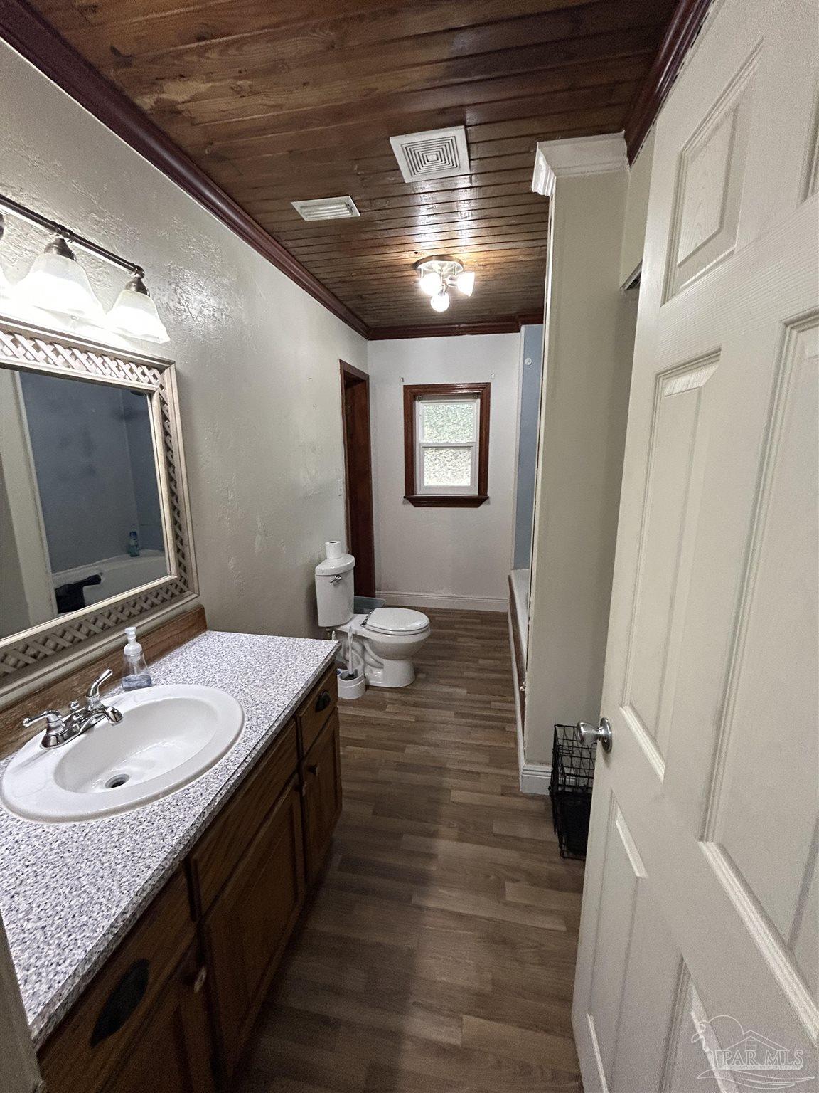 6500 Sanders Street Milton, FL 32570 - Photo 11 of 16 a bathroom with a sink double vanity granite and a mirror
