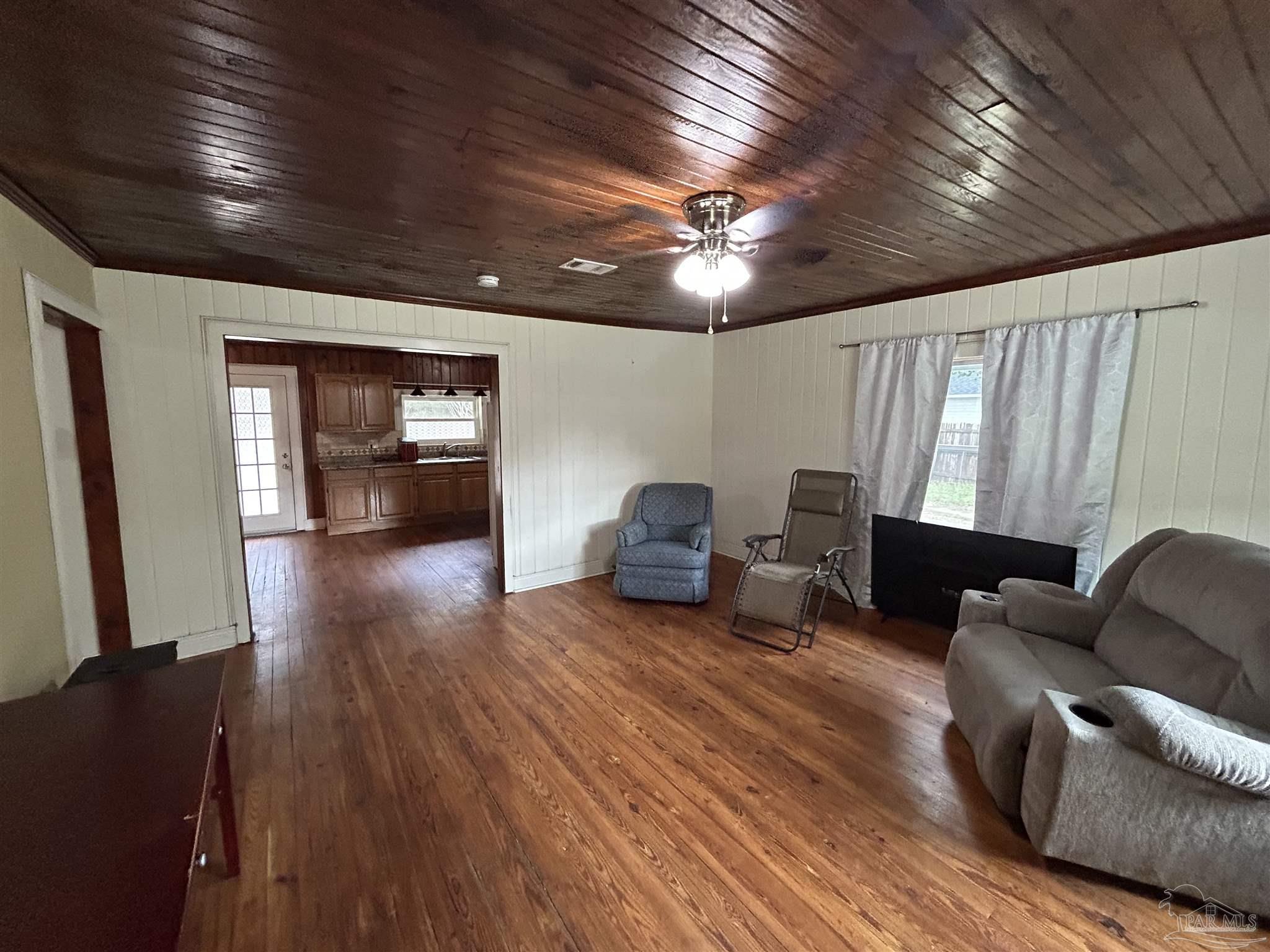 6500 Sanders Street Milton, FL 32570 - Photo 5 of 16 a living room with furniture and a wooden floor