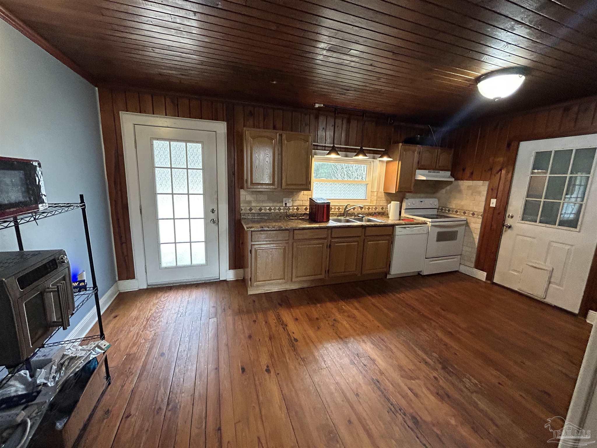 6500 Sanders Street Milton, FL 32570 - Photo 7 of 16 a view of a kitchen with wooden floor and electronic appliances