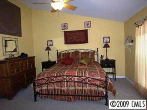 5522 Alexandrite Way Fort Mill, SC 29708 - Photo 6 of 8 a bedroom with a bed and a flat screen tv