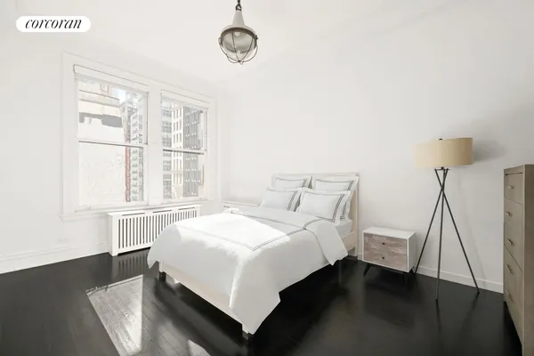 a bedroom with a bed and a large window