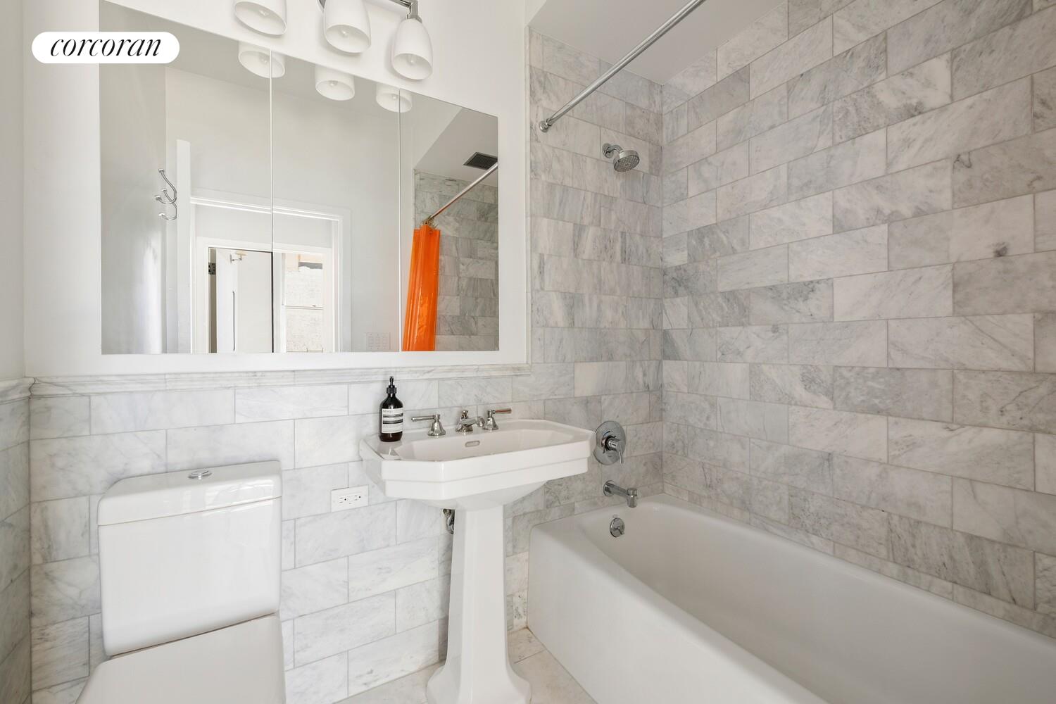 366 Broadway, Unit 4B Manhattan, NY 10013 - Photo 12 of 16 a bathroom with a sink mirror bathtub and shower