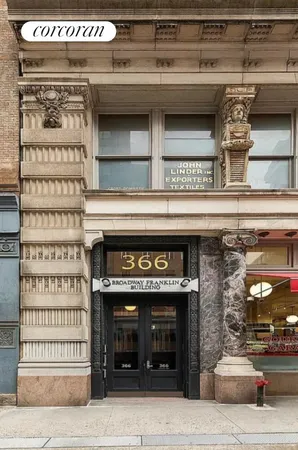 a black and white building with a sign on it
