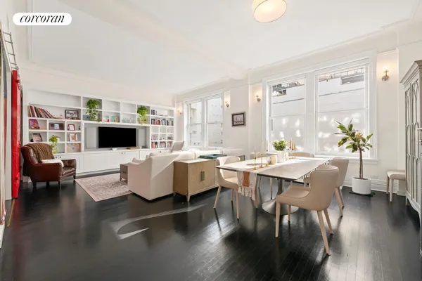 a living room with furniture wooden floor and a flat screen tv
