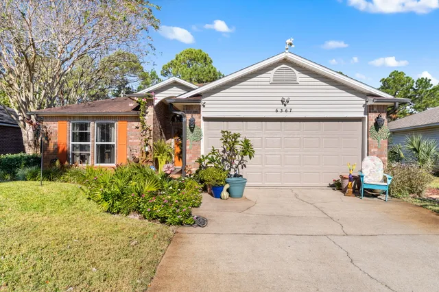 a view of a house with potted plants