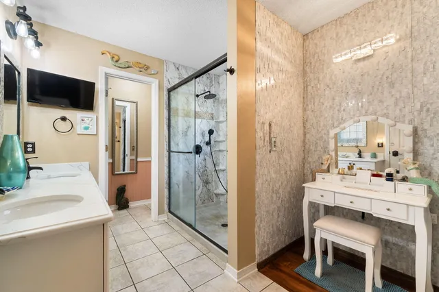 a bathroom with a sink and mirror with toilet
