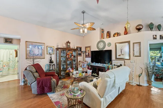 a living room with furniture and a chandelier