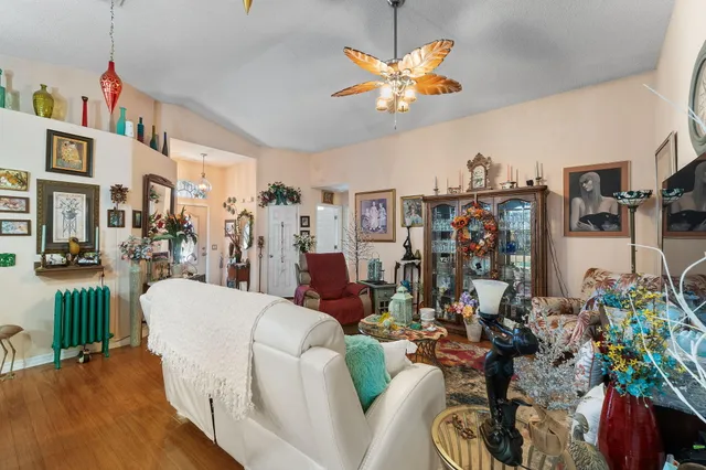 a view of a dining room with furniture wooden floor and a chandelier
