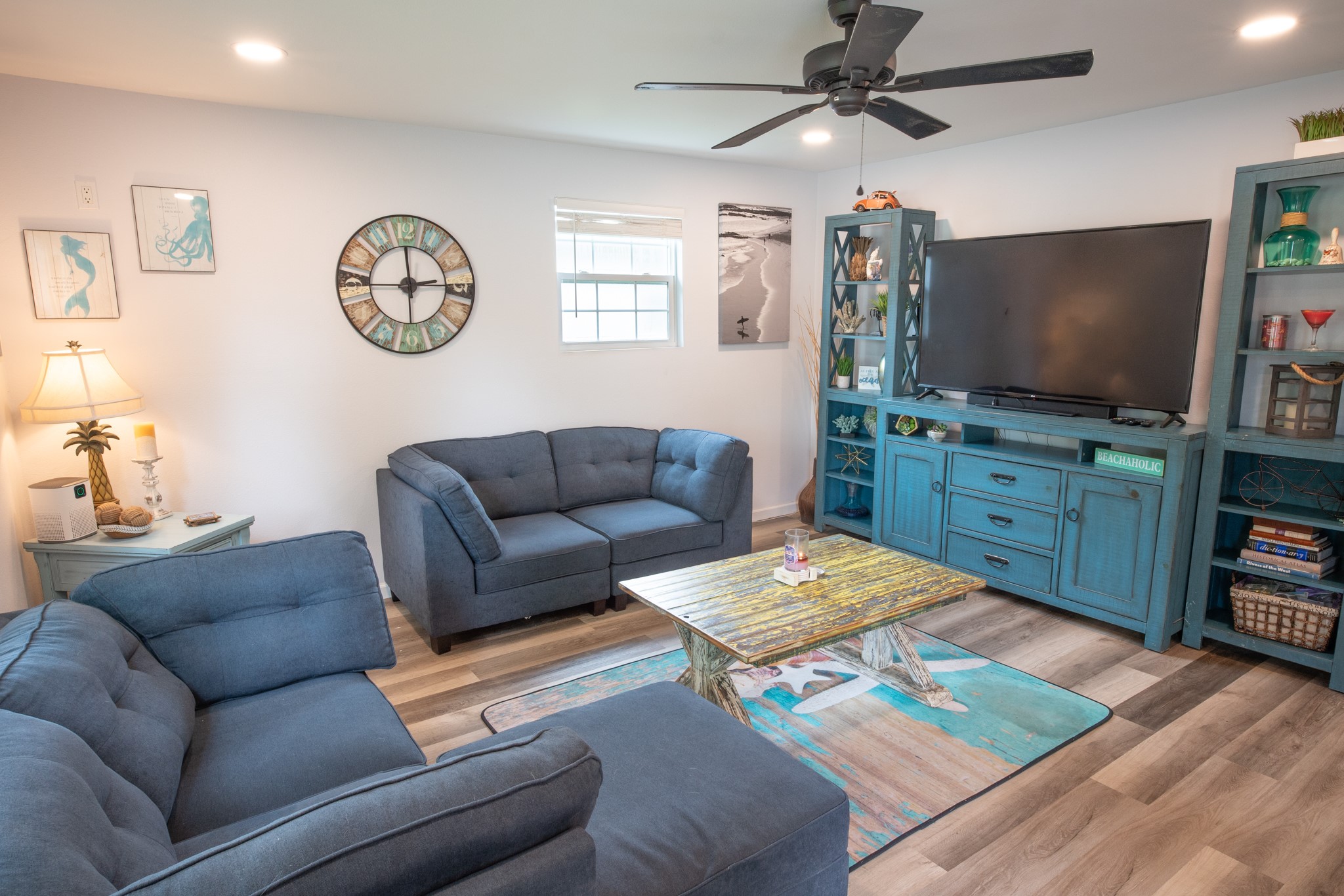 846 South Anderson Street Angleton, TX 77515 - Photo 5 of 30 This cozy living room offers a serene space well-lit with recessed lighting and a ceiling fan. New laminate flooring throughout,