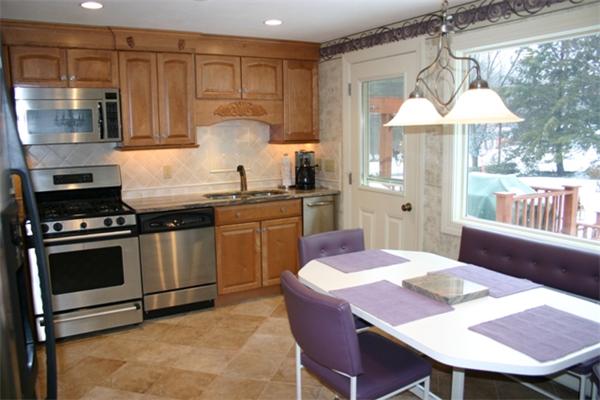 21 Blacksmith Road Wilbraham, MA 01095 - Photo 2 of 16 a kitchen with stainless steel appliances a stove a sink a table and chairs