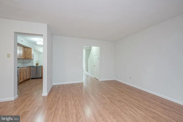 a view of a room with wooden floor and a sink