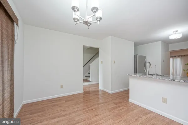 a view of a kitchen with a sink and a refrigerator