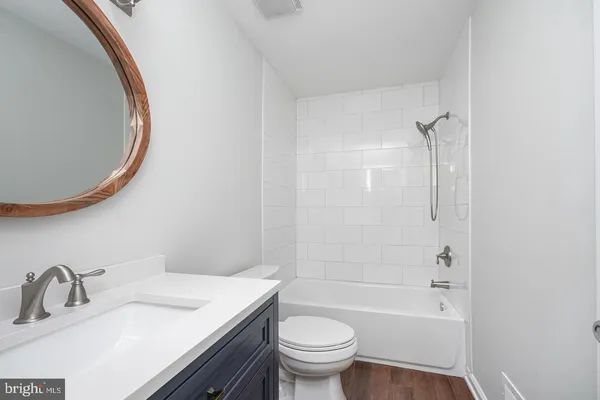 a bathroom with a sink a toilet and a mirror