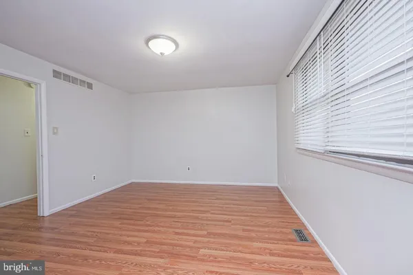 a view of a room with wooden floor and white walls