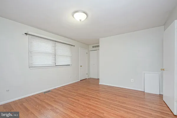 a view of a room with wooden floor and white walls
