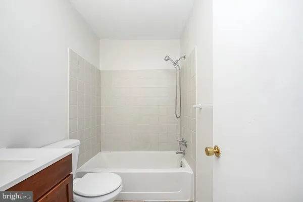 a bathroom with a bathtub and a toilet