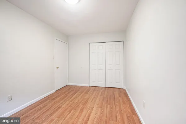 a view of a room with wooden floor