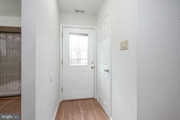 a view of a hallway with wooden floor