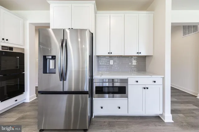 a white refrigerator freezer sitting in a kitchen