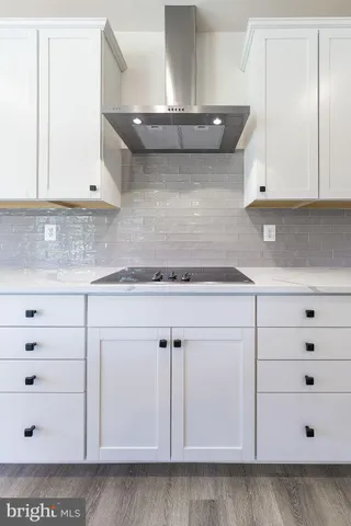 a kitchen with granite countertop white cabinets and white appliances