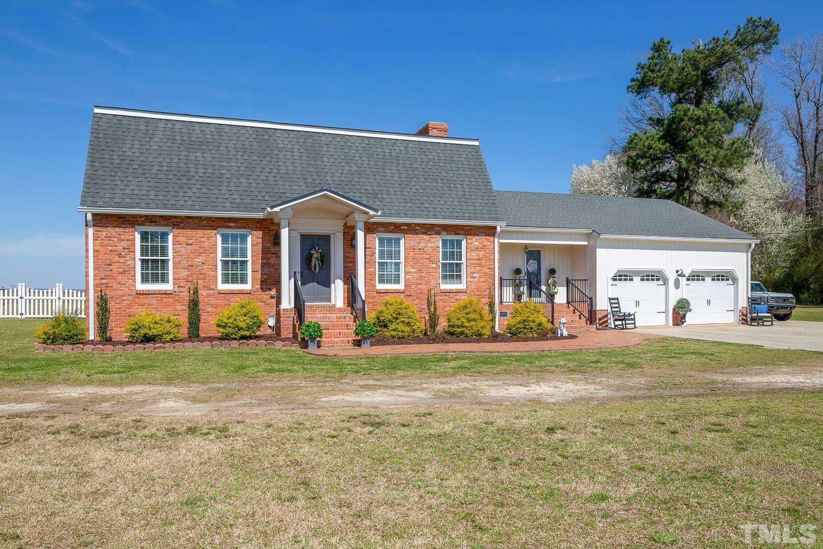 394 Jernigan Loop Road Dunn, NC 28334 - Photo 4 of 39 a front view of a house with a garden and trees