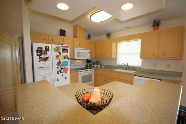 a kitchen with stainless steel appliances granite countertop a sink a refrigerator and a stove