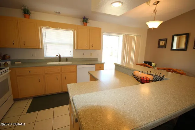 a kitchen with a sink a window and cabinets