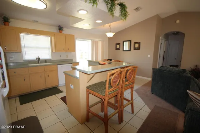 a kitchen with stainless steel appliances a sink a stove a refrigerator and cabinets