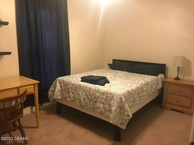 a bedroom with a bed and a table in it