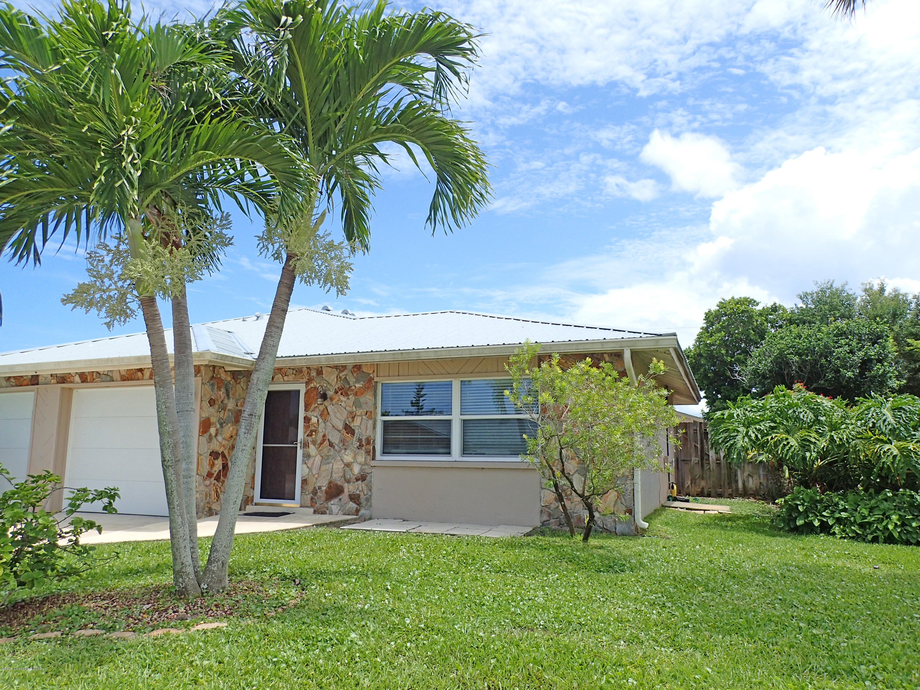 243 Ocean View Lane Melbourne, FL 32903 - Photo 1 of 18 a view of a house with backyard and a tree