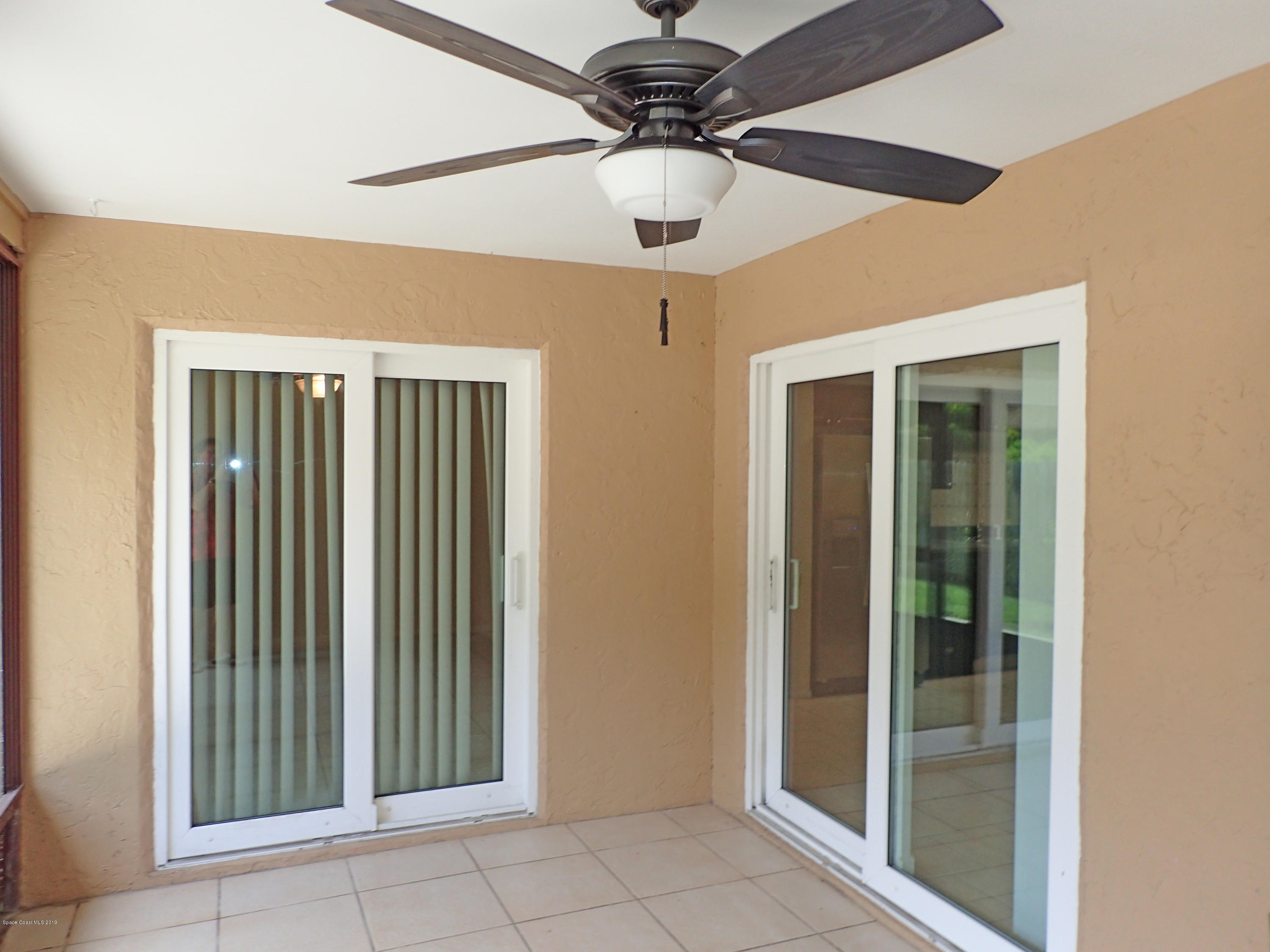 243 Ocean View Lane Melbourne, FL 32903 - Photo 12 of 18 a view of a hallway with a chandelier fan