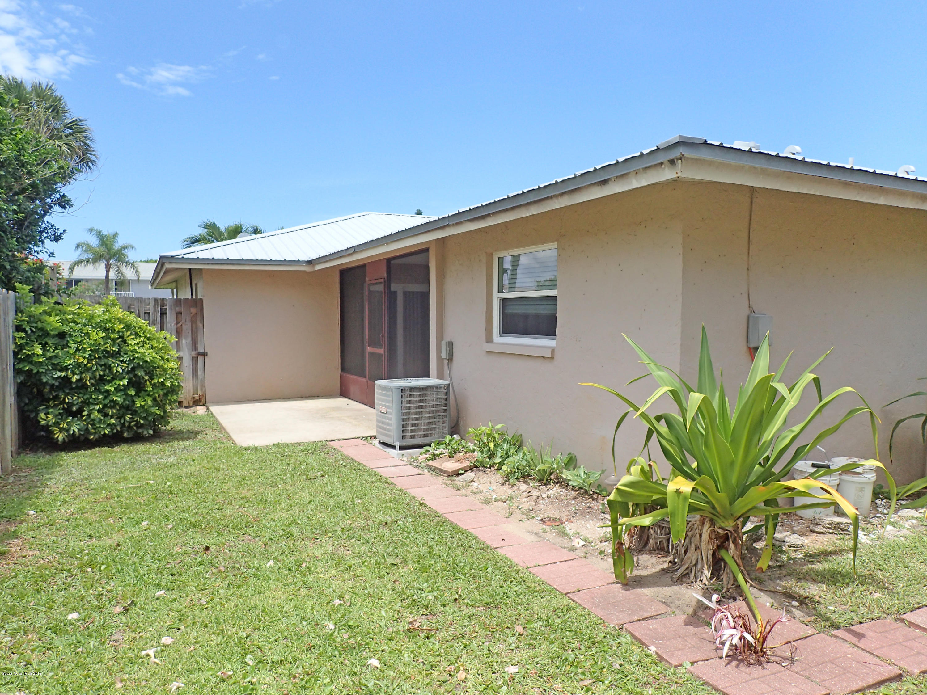 243 Ocean View Lane Melbourne, FL 32903 - Photo 13 of 18 a view of a house with backyard and sitting area