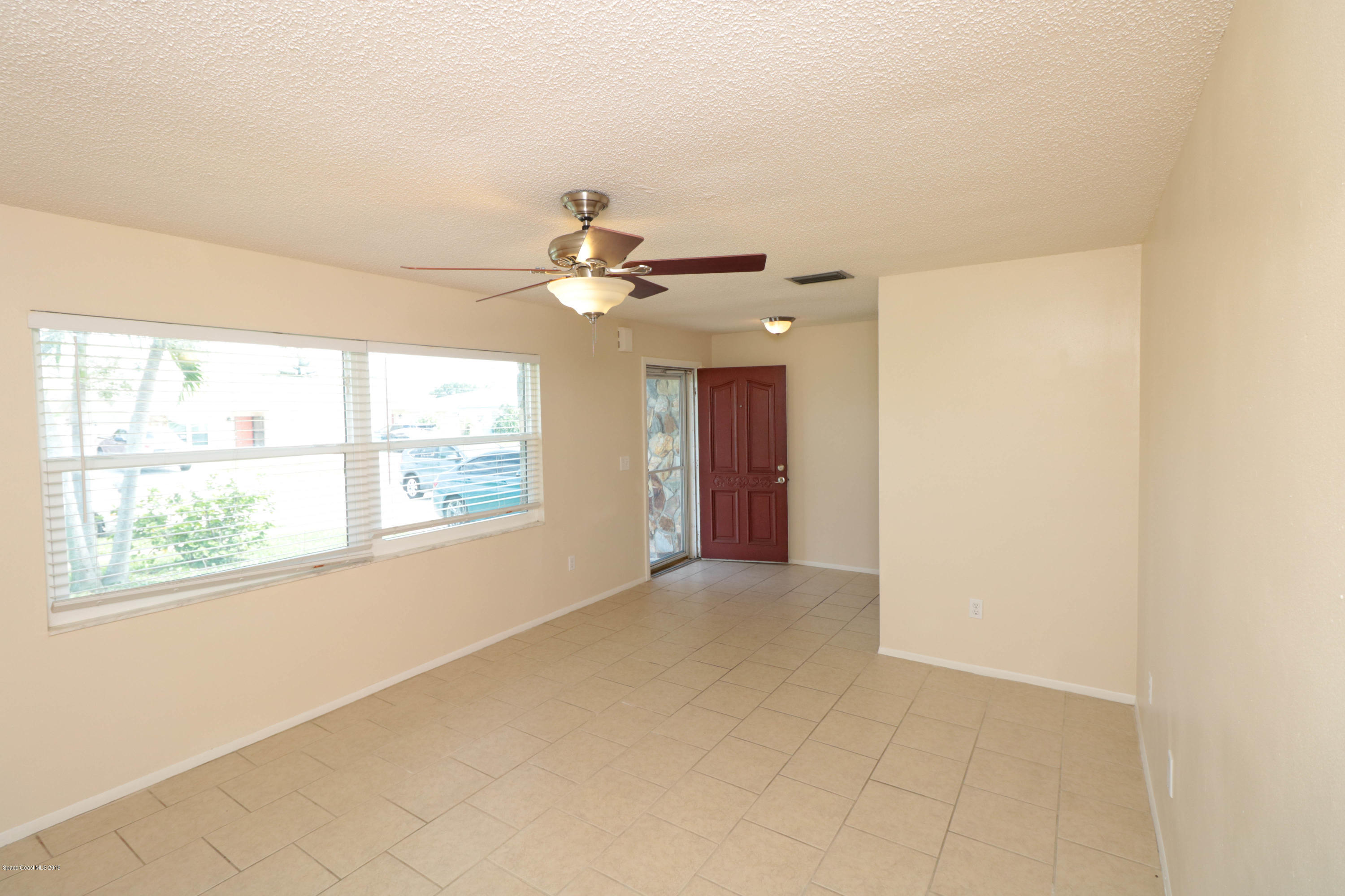 243 Ocean View Lane Melbourne, FL 32903 - Photo 4 of 18 a view of an empty room with a window