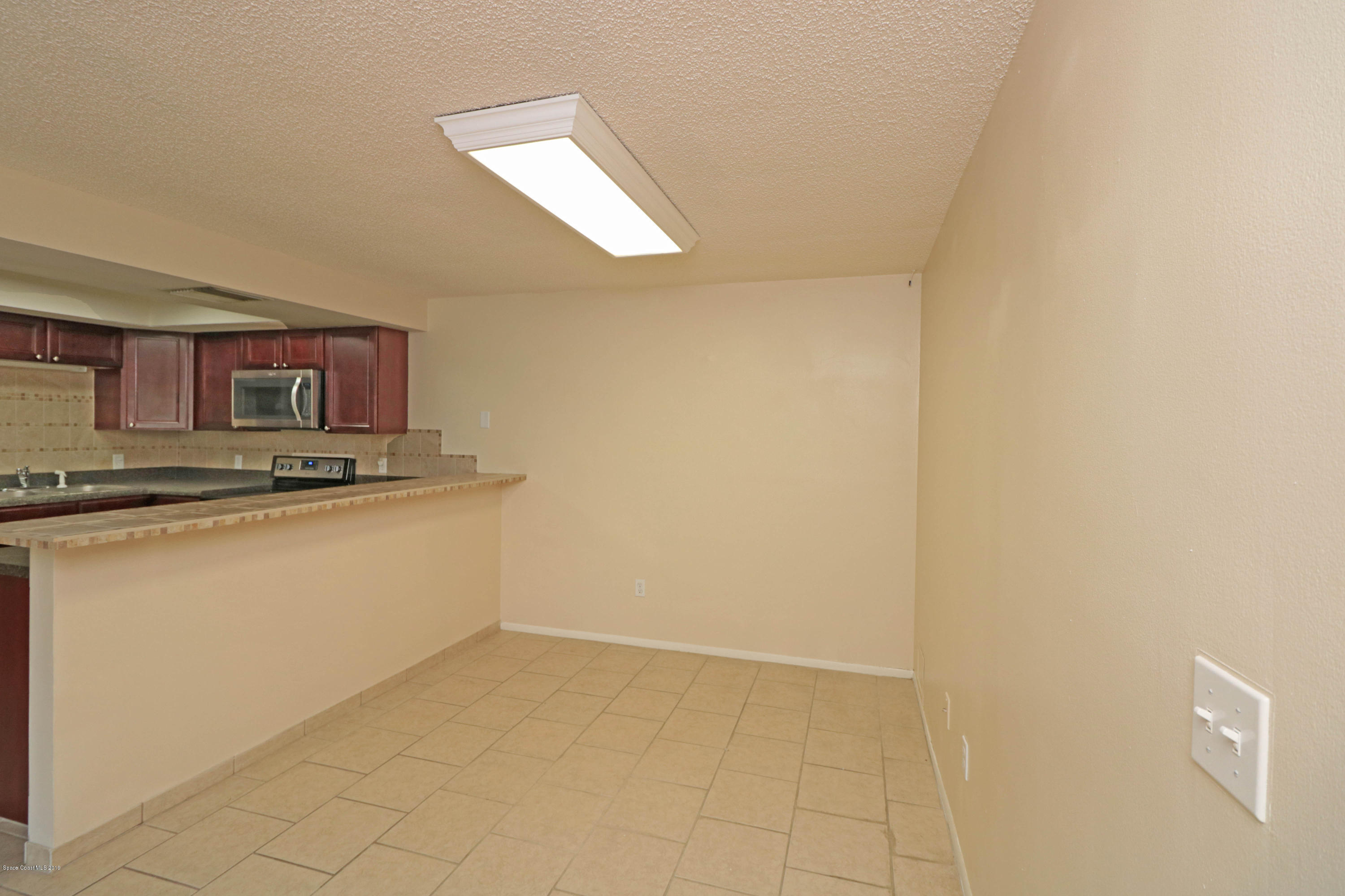 243 Ocean View Lane Melbourne, FL 32903 - Photo 5 of 18 a view of kitchen with granite countertop cabinets and sink