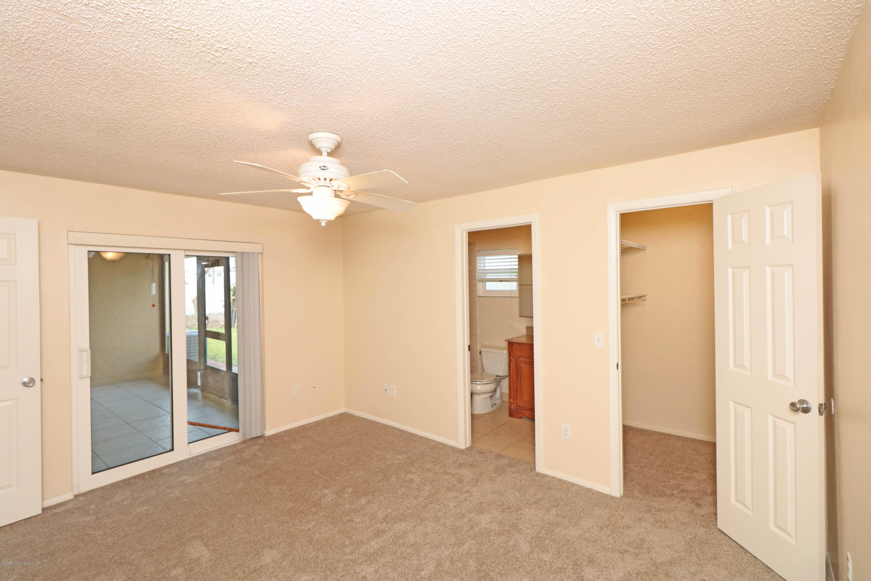 243 Ocean View Lane Melbourne, FL 32903 - Photo 6 of 18 a view of a livingroom with a chandelier fan