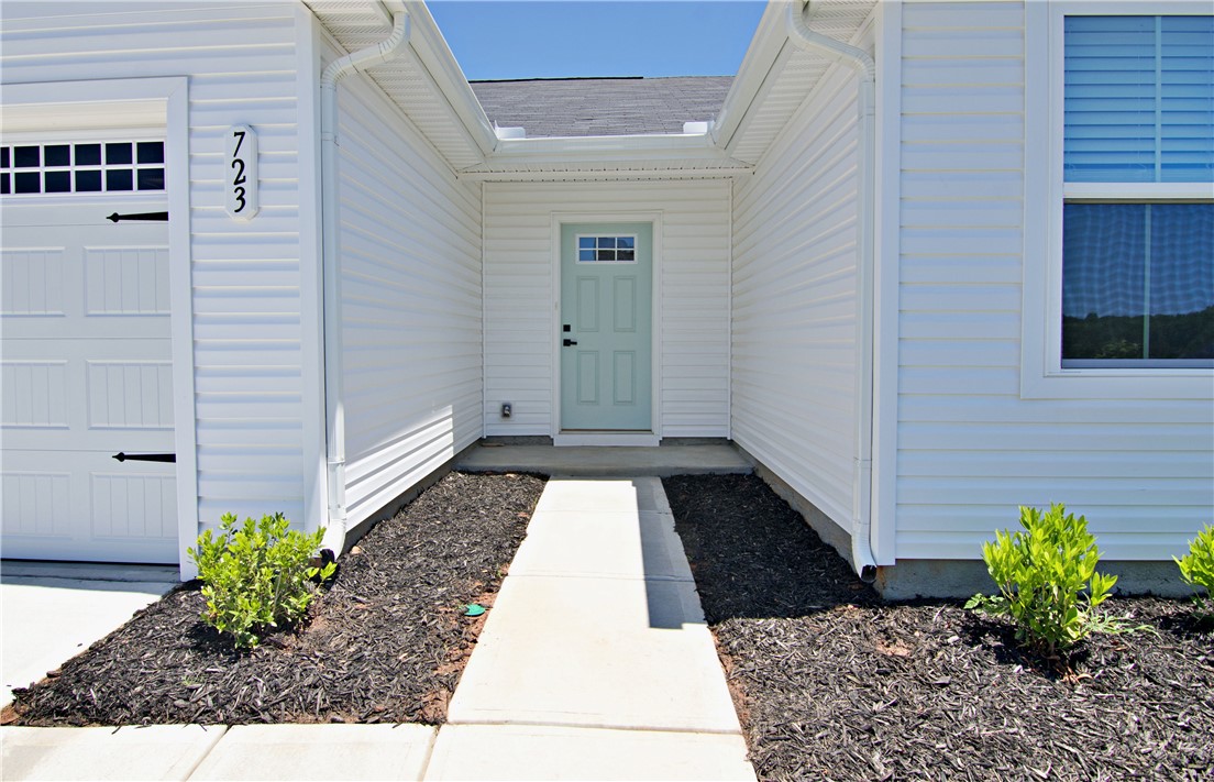 723 Peridot Way Westminster, SC 29693 - Photo 3 of 45 A welcoming front entrance with a light blue door complements the clean white siding.