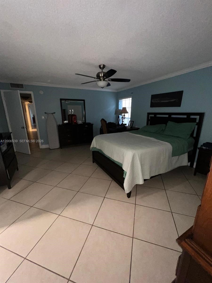 11600 Southwest 83rd Terrace Miami, FL 33173 - Photo 12 of 21 a bedroom with a bed and a chandelier