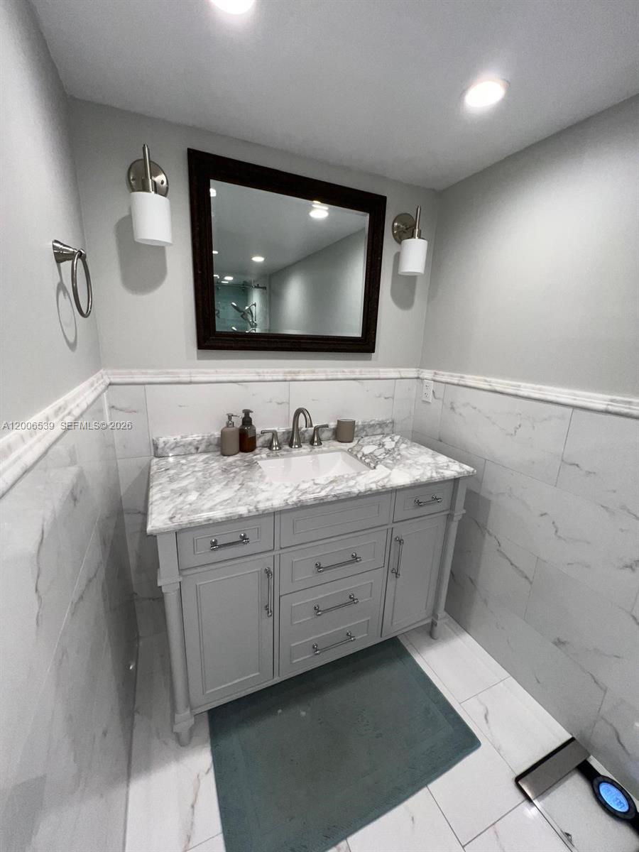 11600 Southwest 83rd Terrace Miami, FL 33173 - Photo 13 of 21 a bathroom with a double vanity sink and a mirror