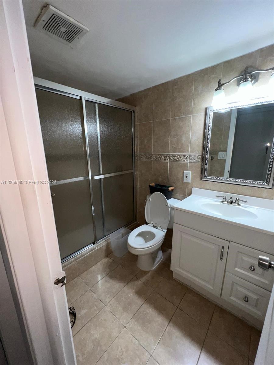 11600 Southwest 83rd Terrace Miami, FL 33173 - Photo 17 of 21 a bathroom with a toilet sink and mirror