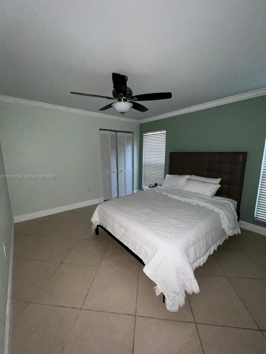 11600 Southwest 83rd Terrace Miami, FL 33173 - Photo 18 of 21 a bed room with a bed and a ceiling fan