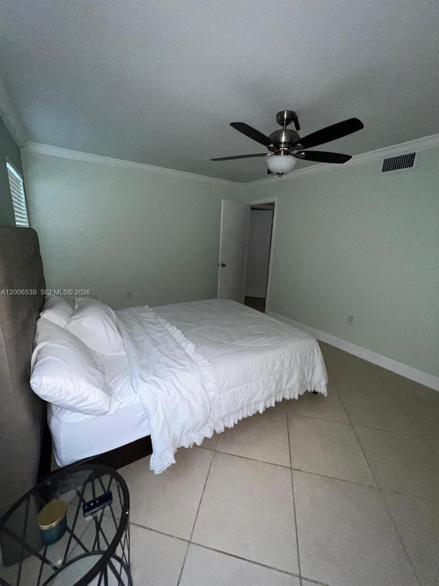 11600 Southwest 83rd Terrace Miami, FL 33173 - Photo 19 of 21 a bedroom with a bed a desk and chair