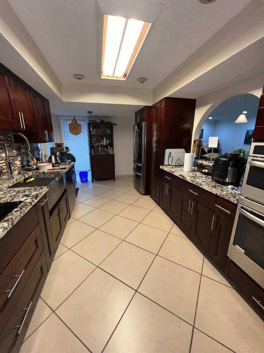 11600 Southwest 83rd Terrace Miami, FL 33173 - Photo 3 of 21 a kitchen with stainless steel appliances granite countertop a stove a sink dishwasher and a refrigerator