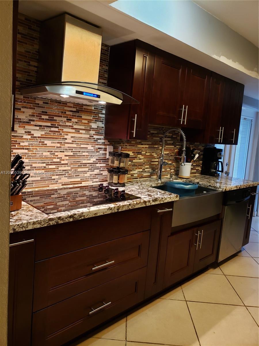 11600 Southwest 83rd Terrace Miami, FL 33173 - Photo 4 of 21 a kitchen with granite countertop a sink and a wooden cabinets