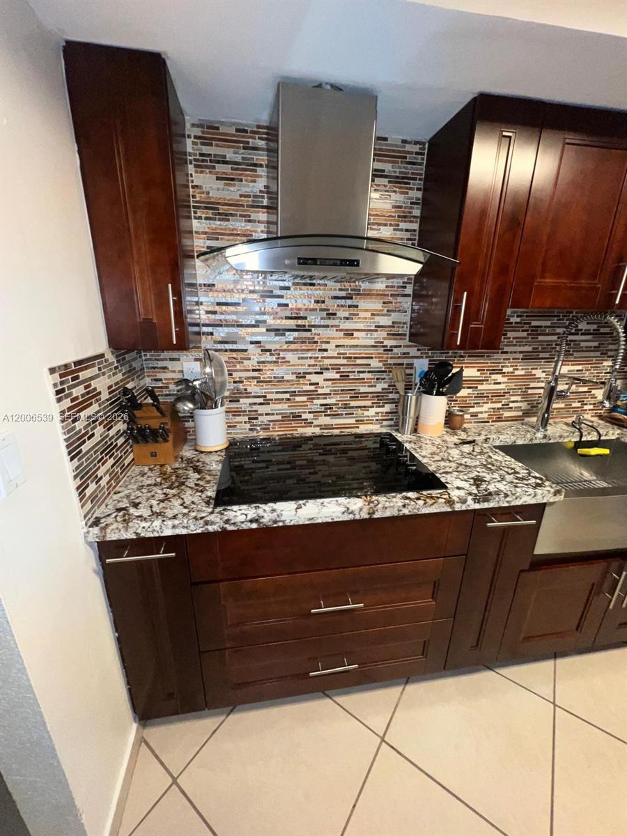 11600 Southwest 83rd Terrace Miami, FL 33173 - Photo 6 of 21 a kitchen with stainless steel appliances granite countertop a stove and a microwave