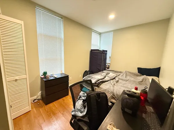 a bed room with a bed and a chair
